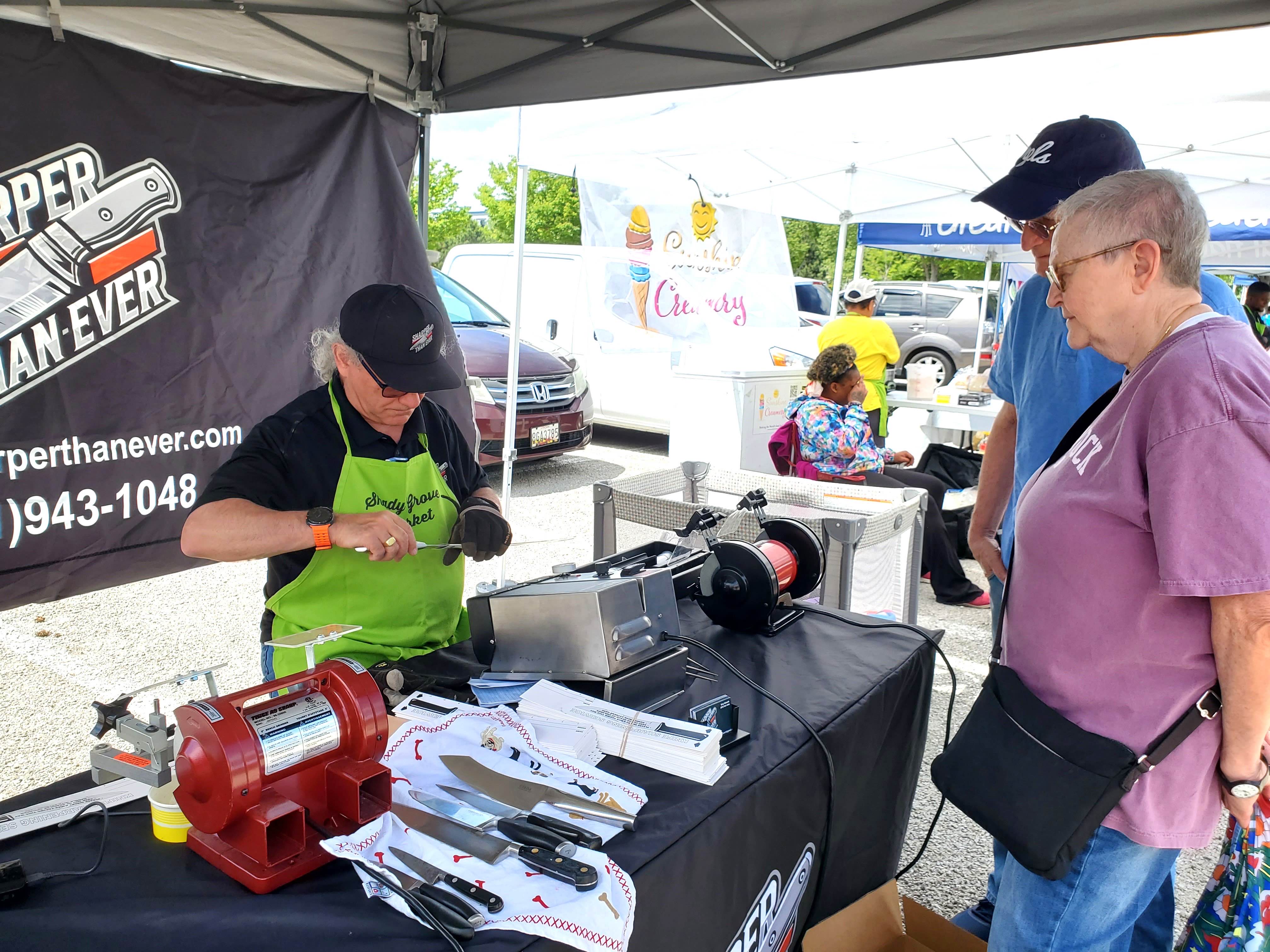 Customer watching knife sharpening demonstration